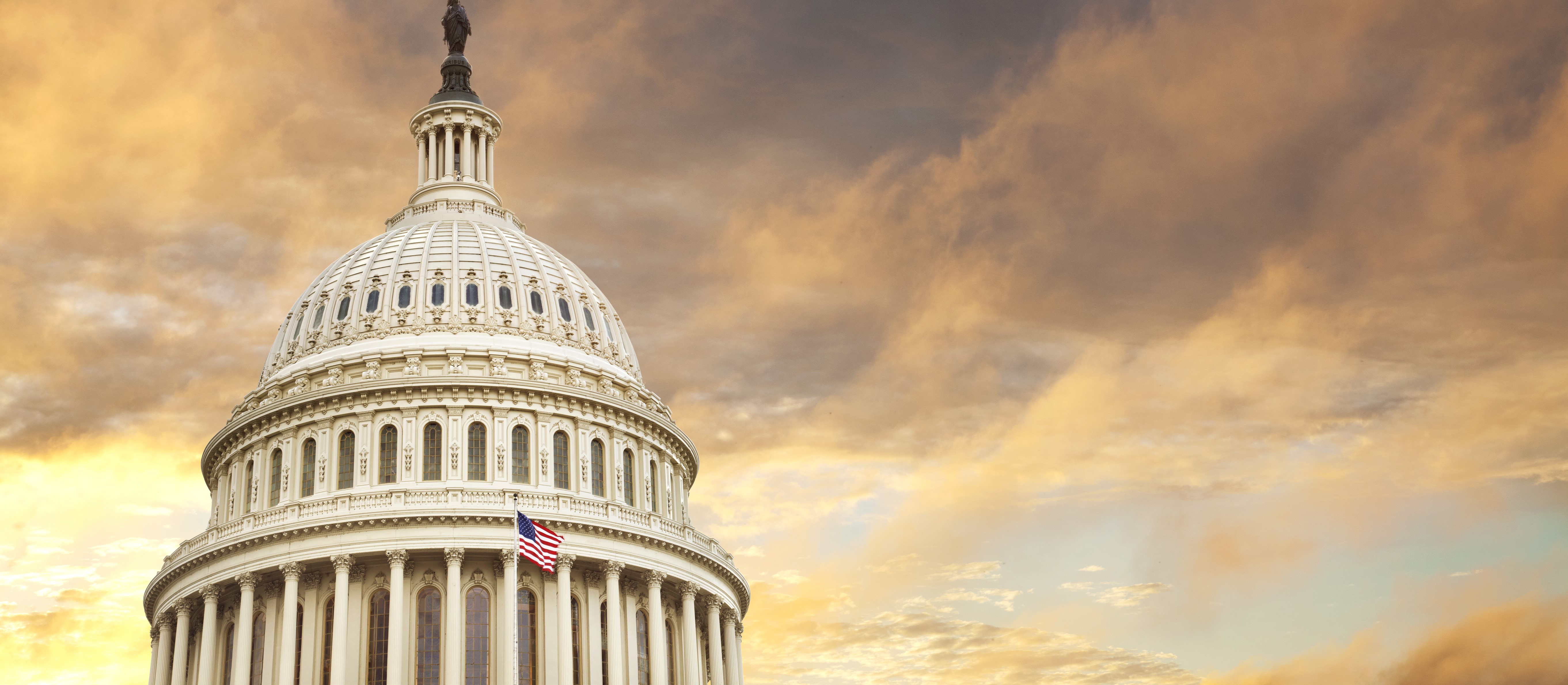 The Capitol dome against a yellow sunset